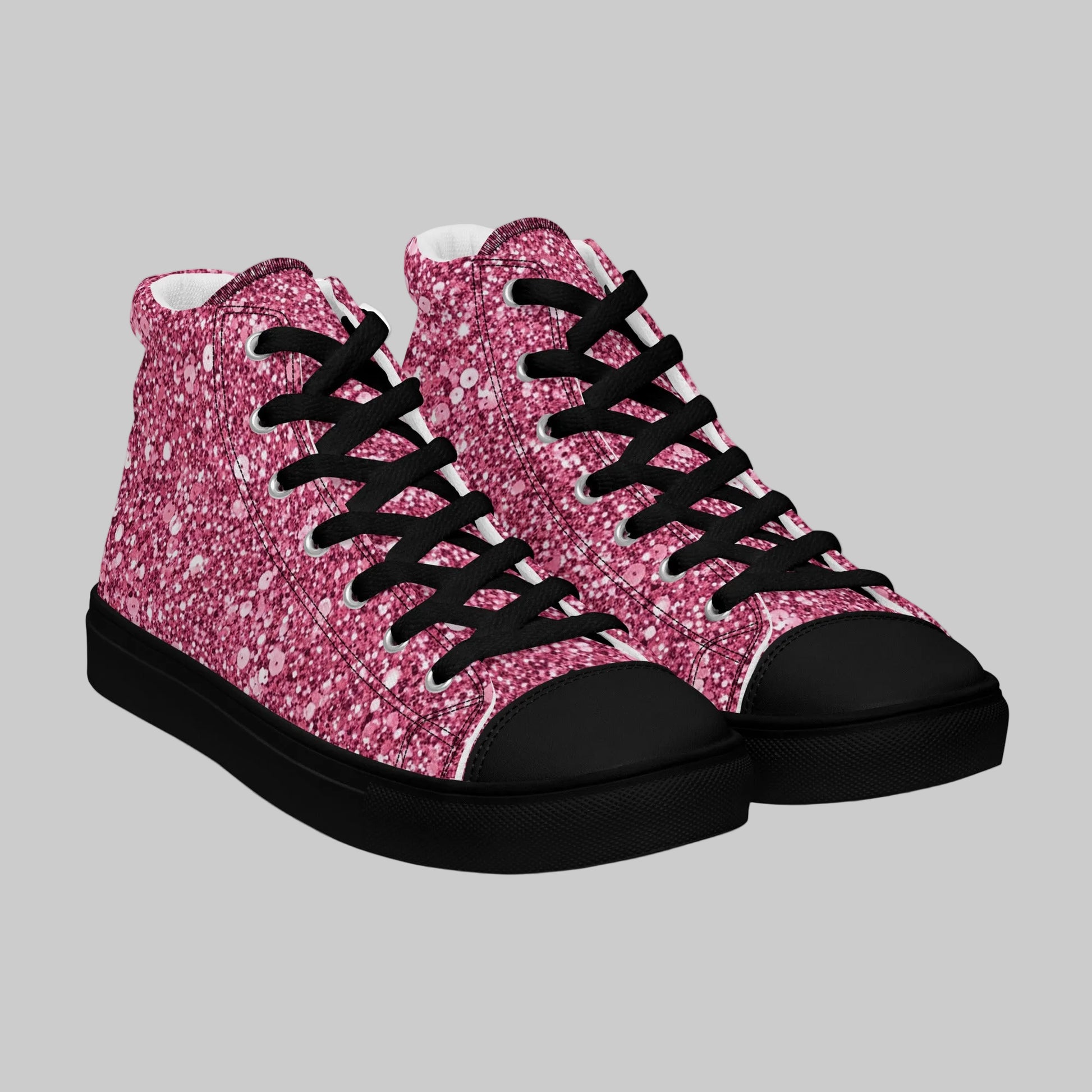 Pair of high-top canvas sneakers featuring a bold pink sparkle print with black faux leather toe caps, black laces, and black rubber soles.