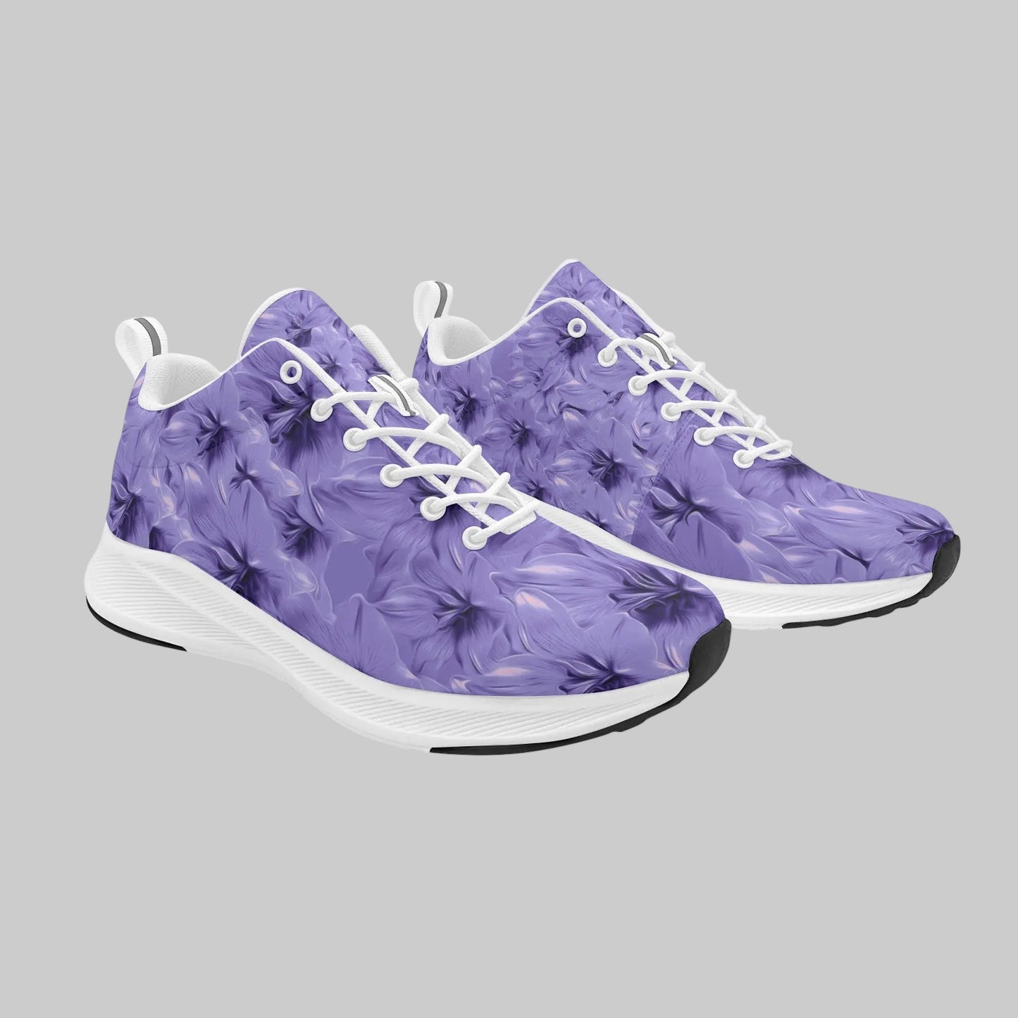 Pair of women's purple floral suede-finish running shoes with white laces and white cushioned soles