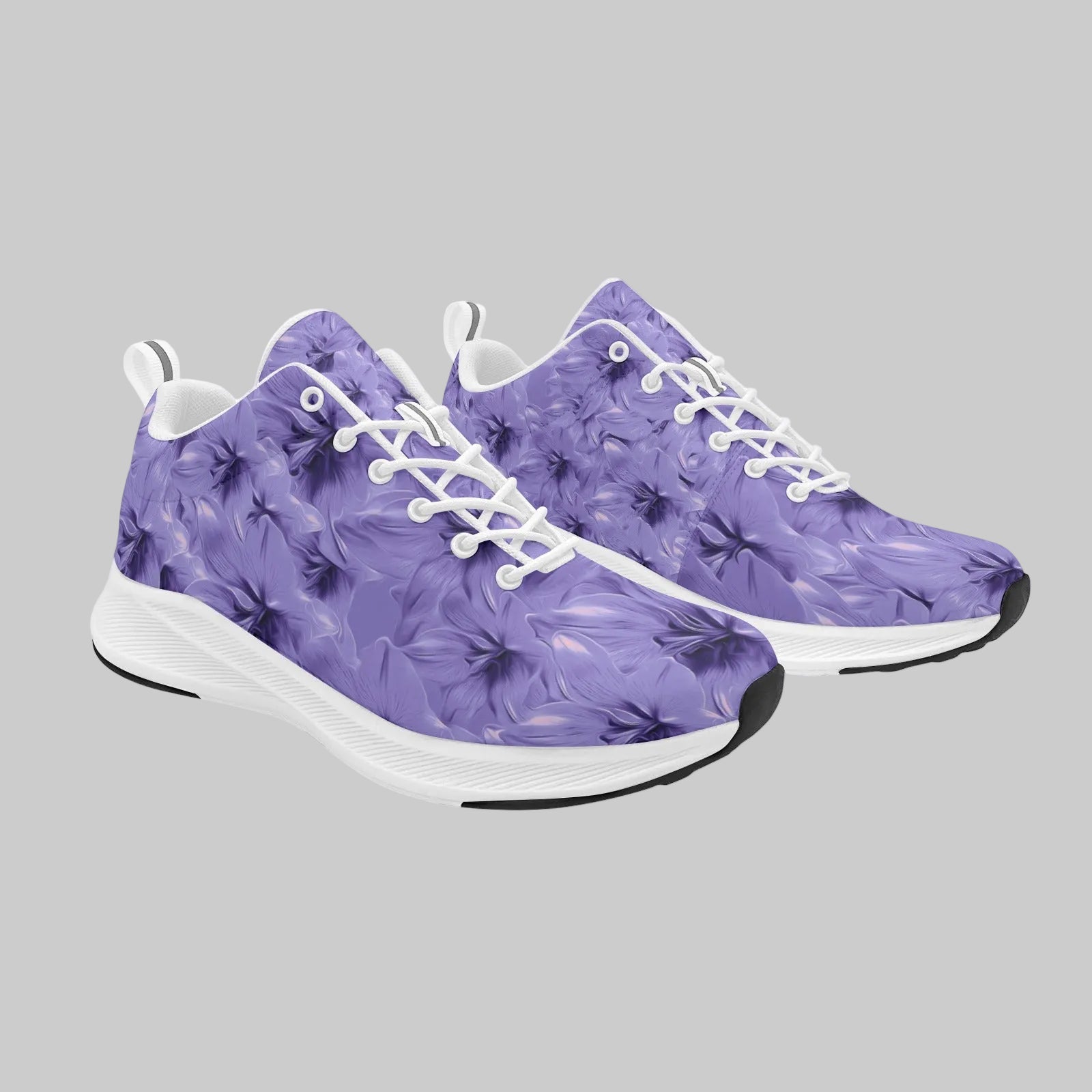 Pair of women's purple floral suede-finish running shoes with white laces and white cushioned soles